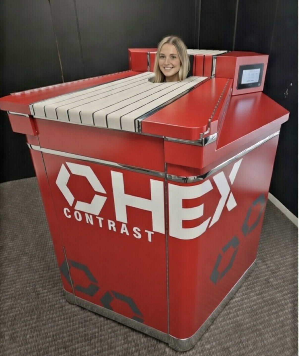 Woman sitting in red HEX Contrast Therapy unit demonstrating comfortable head-out design