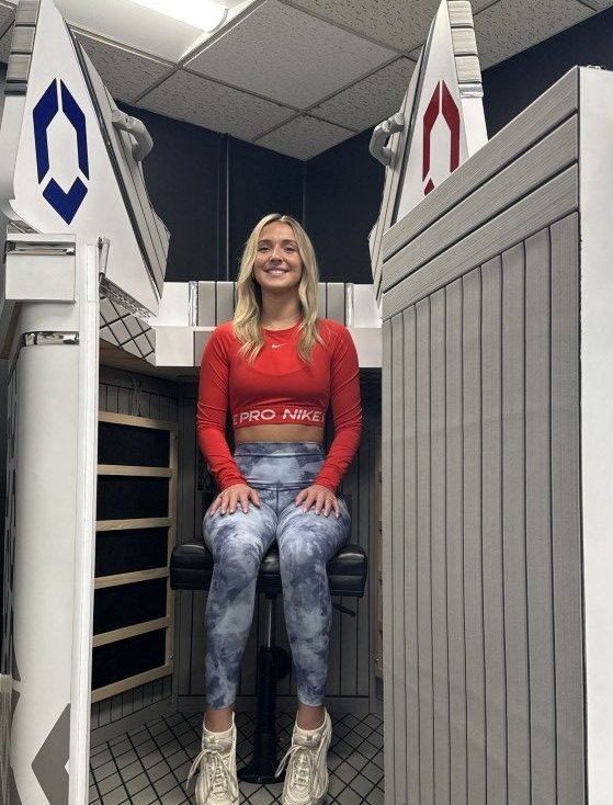 Woman sitting in open HEX Contrast Therapy unit